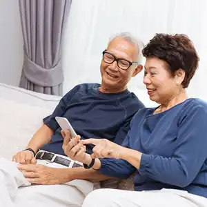 A senior couple files their state taxes using CalFile on their mobile device.